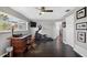 Spacious office featuring dark wood floors, desk, television and exercise machine at 511 Island Way, Clearwater Beach, FL 33767
