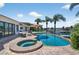 Backyard paradise with a pool, spa, patio, and lush landscaping, ideal for relaxation and leisure at 511 Island Way, Clearwater Beach, FL 33767