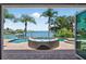 Beautiful waterfront view from the patio with a pool and a comfortable lounge area at 511 Island Way, Clearwater Beach, FL 33767