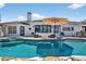 Backyard pool and patio area with lush landscaping, lounge furniture, and spa at 511 Island Way, Clearwater Beach, FL 33767