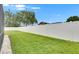 Backyard with white fencing, green lawn and limited landscaping at 5117 Whispering Leaf Trl, Valrico, FL 33596