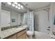 This bathroom features a granite countertop and neutral colors at 5117 Whispering Leaf Trl, Valrico, FL 33596