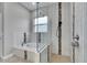Bright bathroom features a walk-in shower with glass door and custom tile work at 5117 Whispering Leaf Trl, Valrico, FL 33596