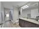 Updated bathroom featuring shower, modern vanity with granite countertop and door to the backyard at 5117 Whispering Leaf Trl, Valrico, FL 33596