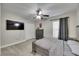 This bedroom has a large TV, ceiling fan, and spacious closet at 5117 Whispering Leaf Trl, Valrico, FL 33596
