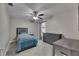 A bedroom showcases a ceiling fan and a view of the backyard at 5117 Whispering Leaf Trl, Valrico, FL 33596