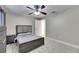 Cozy bedroom with neutral colors, ceiling fan, and soft carpeting at 5117 Whispering Leaf Trl, Valrico, FL 33596