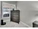 Cozy bedroom featuring a gray dresser and a window that offers ample natural light at 5117 Whispering Leaf Trl, Valrico, FL 33596