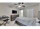 This bedroom has a TV, keyboard, closet, and neutral paint at 5117 Whispering Leaf Trl, Valrico, FL 33596