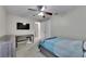 A bedroom has a ceiling fan and closet; fresh paint at 5117 Whispering Leaf Trl, Valrico, FL 33596