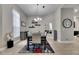 Dining room featuring a gray wood table with six chairs, modern chandelier, and stylish decorations at 5117 Whispering Leaf Trl, Valrico, FL 33596