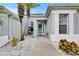 Inviting home entrance features a charming courtyard with decorative stone and covered doorway at 5117 Whispering Leaf Trl, Valrico, FL 33596
