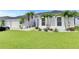 Charming home featuring lush green lawn, complemented by palm trees and beautiful white rock landscaping at 5117 Whispering Leaf Trl, Valrico, FL 33596