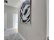 Hallway featuring neutral paint, modern art, and carpeted floors at 5117 Whispering Leaf Trl, Valrico, FL 33596