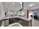 Modern kitchen features granite counters, stainless appliances, and is open to the living area at 5117 Whispering Leaf Trl, Valrico, FL 33596