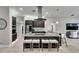Spacious kitchen island with sleek appliances, pendant lighting, and bar stool seating at 5117 Whispering Leaf Trl, Valrico, FL 33596