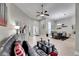 Spacious living room showcasing tile floors, modern décor, ceiling fan, and open access to dining area at 5117 Whispering Leaf Trl, Valrico, FL 33596