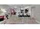 Open-concept living room with breakfast bar, modern decor, and light wood-look floors at 5117 Whispering Leaf Trl, Valrico, FL 33596