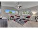 Bright living room features neutral tones, vaulted ceilings, and stylish decor for comfortable and sophisticated living at 5117 Whispering Leaf Trl, Valrico, FL 33596