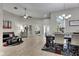 Open floor plan showcasing living room and dining area with lots of natural light and access to foyer at 5117 Whispering Leaf Trl, Valrico, FL 33596