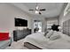 Spacious main bedroom with a tray ceiling, neutral colors, and a sliding door leading to the outdoors at 5117 Whispering Leaf Trl, Valrico, FL 33596