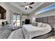 Relaxing main bedroom features a large window, plush carpet, and modern furnishings for a cozy retreat at 5117 Whispering Leaf Trl, Valrico, FL 33596