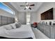 Serene main bedroom boasts neutral tones, a comfortable seating area, and a window view for a peaceful retreat at 5117 Whispering Leaf Trl, Valrico, FL 33596