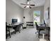 Bright home office featuring two desks, a window view, and workout equipment at 5117 Whispering Leaf Trl, Valrico, FL 33596
