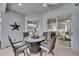 Cozy outdoor seating area with a modern table and chairs under a ceiling fan at 5117 Whispering Leaf Trl, Valrico, FL 33596