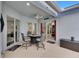 Stylish covered patio with a seating area, sliding doors, and attractive decor at 5117 Whispering Leaf Trl, Valrico, FL 33596
