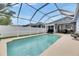 A screened-in pool offers a refreshing escape, perfect for relaxation and outdoor enjoyment at 5117 Whispering Leaf Trl, Valrico, FL 33596