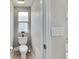 Cozy powder room featuring a toilet, small window and neutral paint at 5117 Whispering Leaf Trl, Valrico, FL 33596