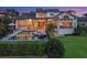Gorgeous backyard features a fenced pool and spa, lush landscaping, and a covered outdoor living area at 5287 61St S Ave, St Petersburg, FL 33715