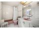 Bright bathroom featuring a bathtub, vanity, and an adjacent door to another room at 5287 61St S Ave, St Petersburg, FL 33715