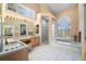 The bright bathroom includes a soaking tub under a window and a separate shower at 5287 61St S Ave, St Petersburg, FL 33715