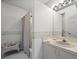 Clean and simple bathroom with a shower, white vanity, and floral accents at 5287 61St S Ave, St Petersburg, FL 33715