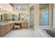 The bright bathroom includes double sinks, a soaking tub and a separate shower at 5287 61St S Ave, St Petersburg, FL 33715