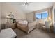 Cozy bedroom with a queen size bed, a ceiling fan, and a window at 5287 61St S Ave, St Petersburg, FL 33715