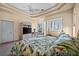 Spacious bedroom featuring a ceiling fan, patterned bedding, and a decorative window with outdoor view at 5287 61St S Ave, St Petersburg, FL 33715
