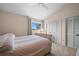 Cozy bedroom features neutral walls, large closet, and a window view overlooking a beautiful, sunny day at 5287 61St S Ave, St Petersburg, FL 33715