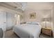 This bedroom features a serene bed, ceiling fan and a lamp resting on a wooden bedside table at 5287 61St S Ave, St Petersburg, FL 33715