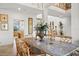 Open concept dining area with a large table, ornate vase, and stylish chairs with view to kitchen at 5287 61St S Ave, St Petersburg, FL 33715
