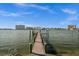 This long, wooden dock sits on calm water and leads out to an open and expansive view of the cityscape at 5287 61St S Ave, St Petersburg, FL 33715