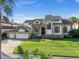 Stately two-story home with a three-car garage, manicured lawn, and well-maintained landscaping at 5287 61St S Ave, St Petersburg, FL 33715