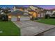Beautiful two-story home with a three-car garage, brick accents, and lush landscaping at 5287 61St S Ave, St Petersburg, FL 33715