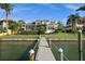 Beautiful waterfront home with a private dock, lush landscaping, and large windows at 5287 61St S Ave, St Petersburg, FL 33715