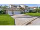 Spacious luxury home featuring an attached three-car garage, lush lawn and brick accents at 5287 61St S Ave, St Petersburg, FL 33715