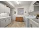 Bright laundry room with ample storage cabinets, countertop space, and modern appliances at 5287 61St S Ave, St Petersburg, FL 33715