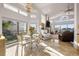 Open-concept living area with high ceilings, expansive windows, and a cozy breakfast nook at 5287 61St S Ave, St Petersburg, FL 33715