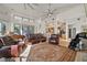 Spacious living room features hardwood floors, a large patterned rug, and plush leather seating at 5287 61St S Ave, St Petersburg, FL 33715